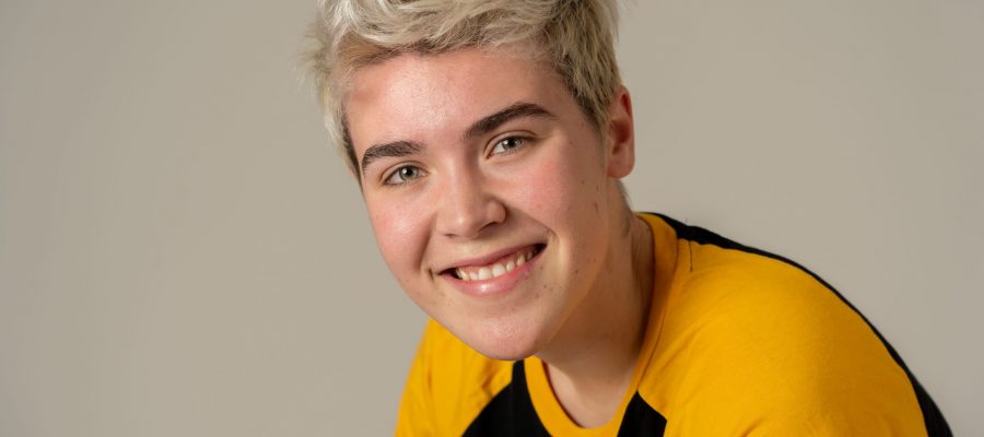 Portrait of young attractive stylish fashion teenager confident and happy with his gender identity. Trans boy posing in cool urban fashion t shirt. In Beauty, Transgender people and Equality concept.